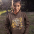 This hoodie features a beautifully detailed owl perched on a branch, surrounded by a scattering of warm-toned autumn leaves.